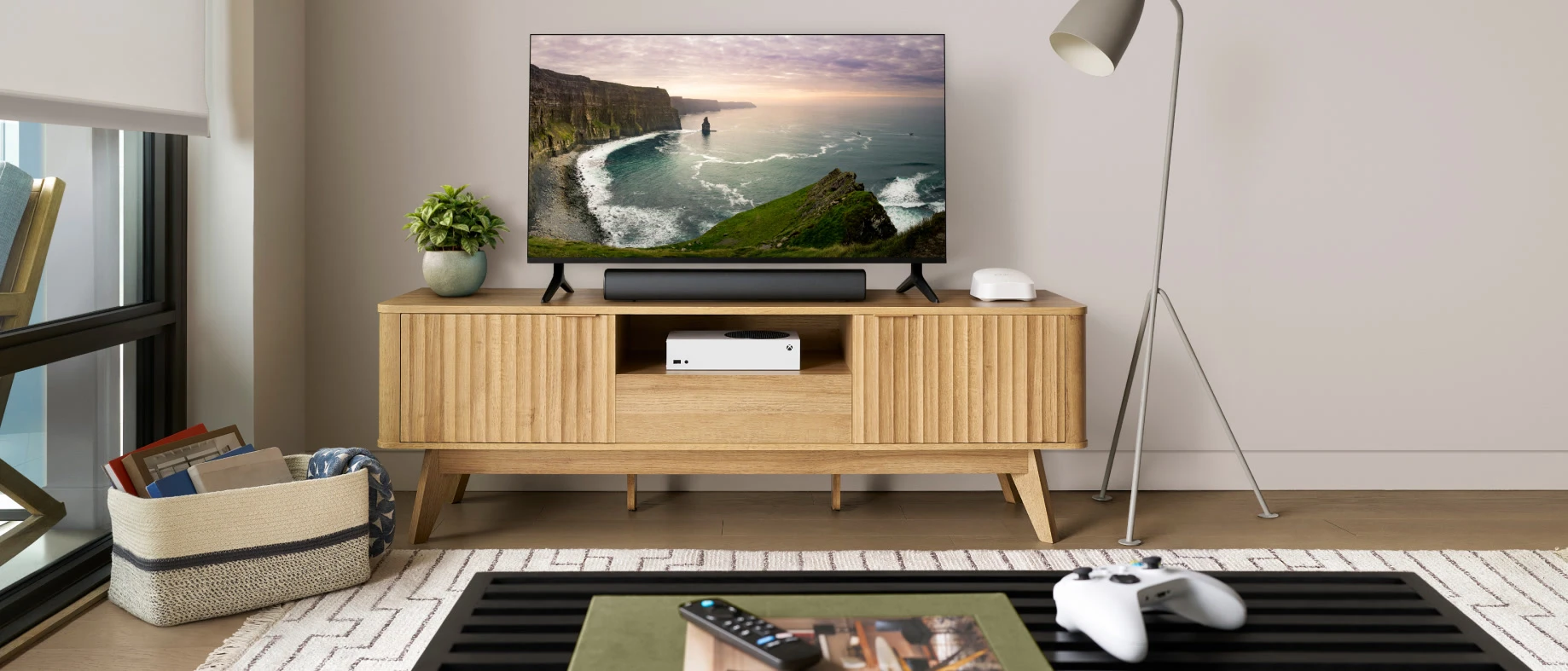 An eero 7 router placed in the open on a living-room media cabinet
