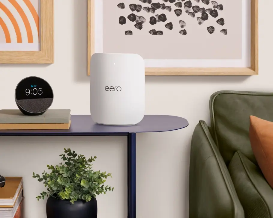 An eero Max 7 router placed upright on a side table