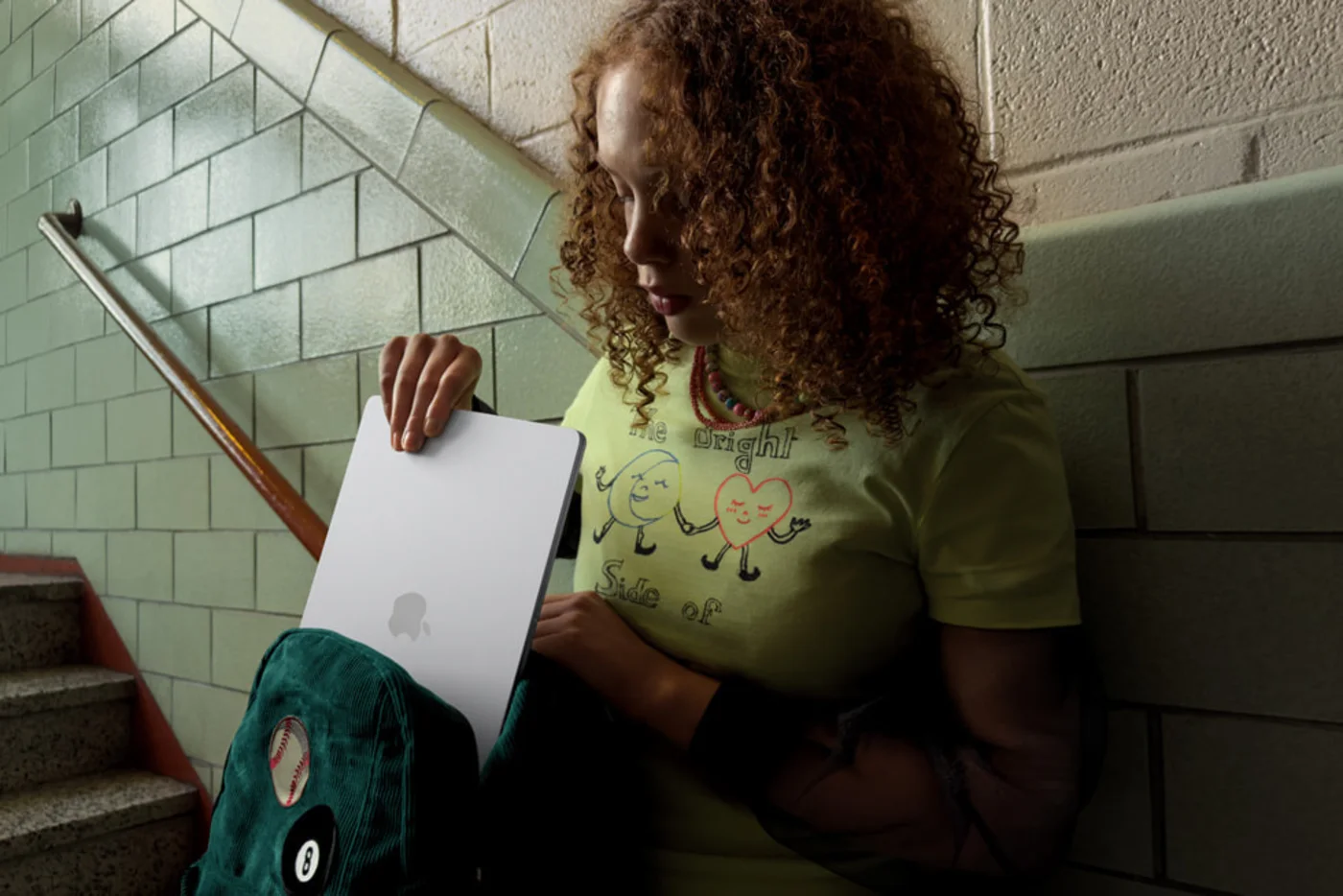 Person carrying a closed 13-inch MacBook Air M5