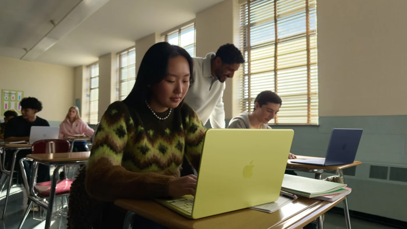 Students using MacBook Neo laptops in a classroom