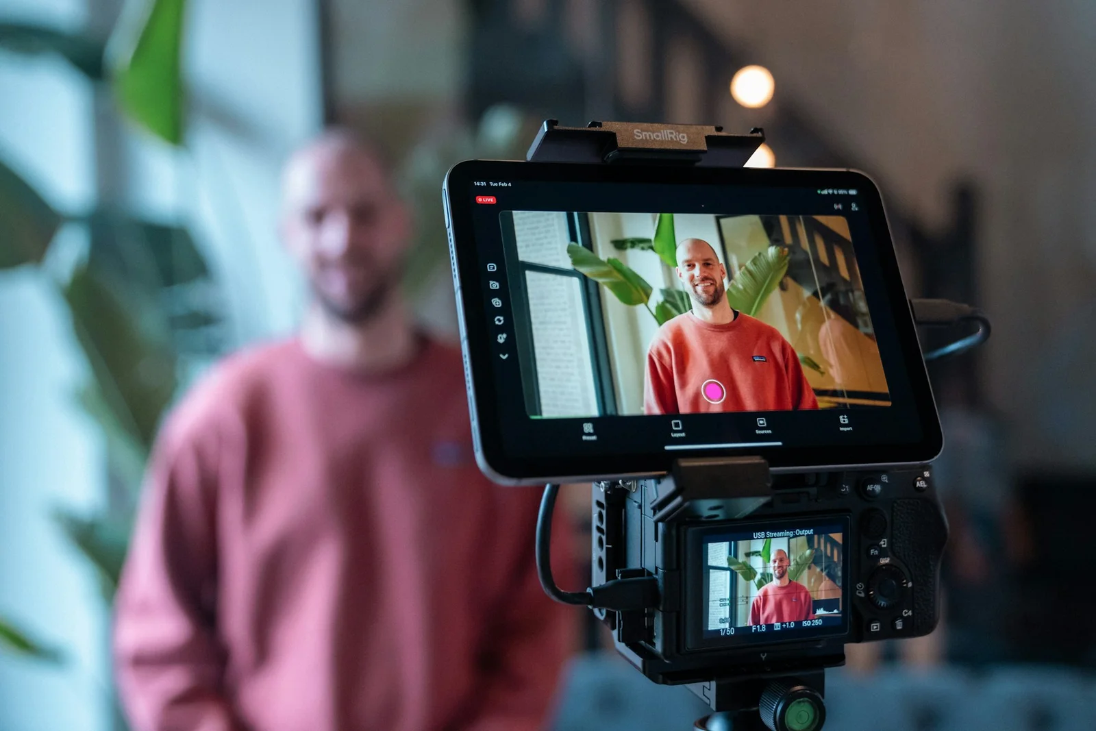 Creator recording video with a camera and mobile display